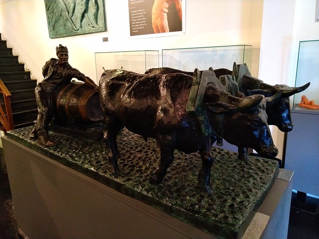 Sculpture of worker driving oxen hauling port wine. 