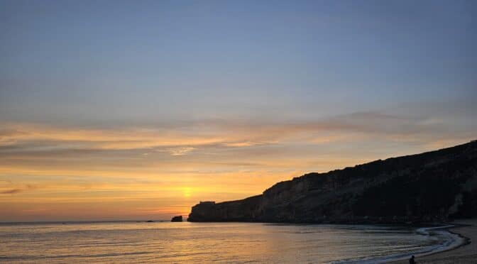 Walking on the beach at sunse in Nazare. A Portuguese Adventure by Paulo Figueira