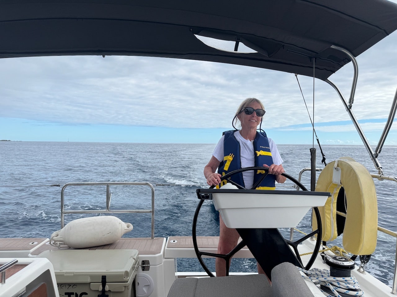 Barbara Nevins Taylor at the helm of Easy Wind 